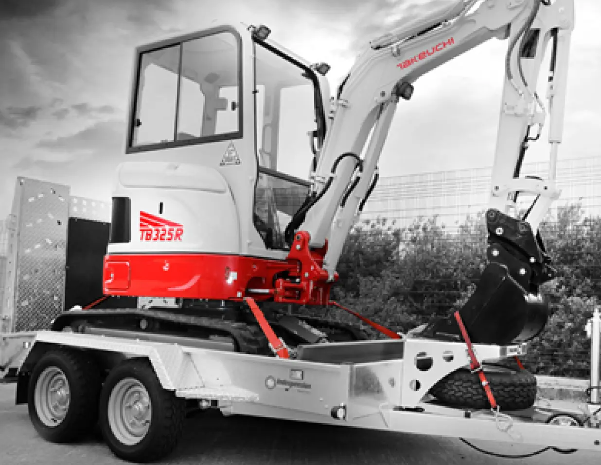 Takeuchi TB325R 2.5 tonne digger loaded on a trailer for delivery